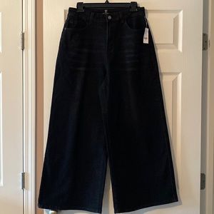Cropped black jeans with wide legs.